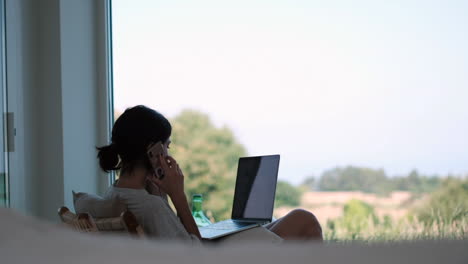 remote work: woman with laptop and phone in nature home office