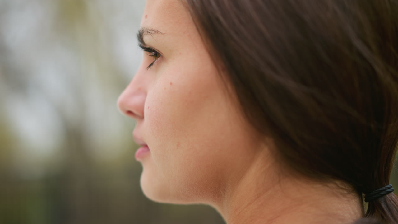 Side close-up view of lady's face with visible goosebumps, natural skin texture, emotional response, sensation of cold or excitement, subtle beauty shot, youthful appearance, soft focus