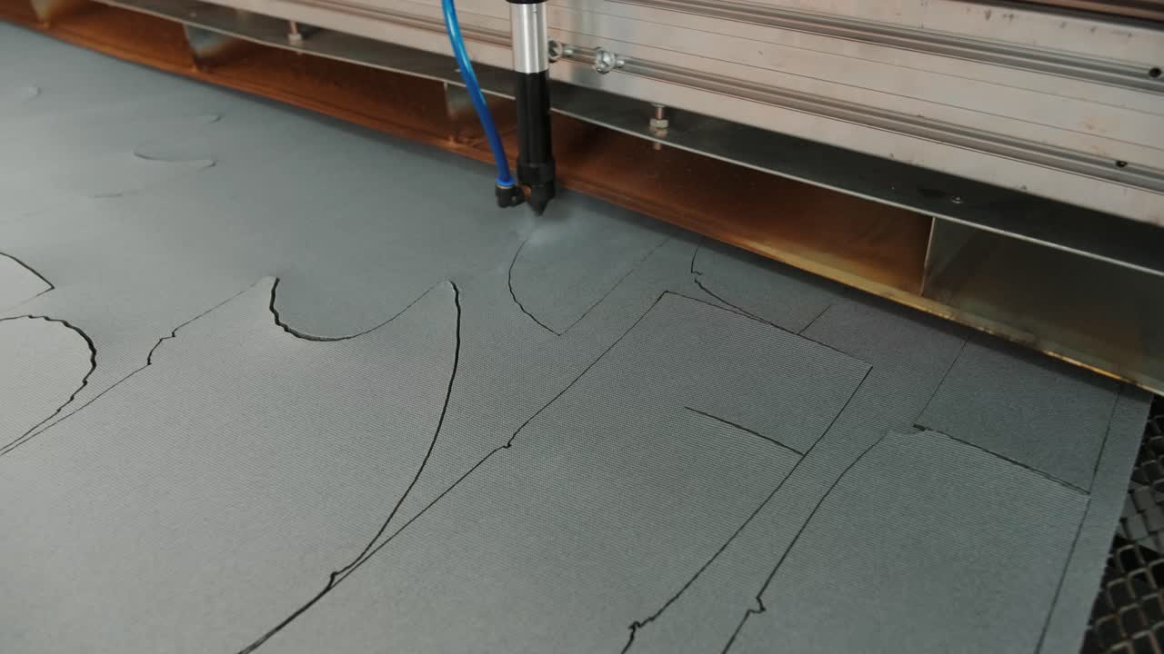 CNC machine for cutting fabrics textile materials and leather, laser marking and measurement. Modern footwear production.