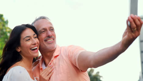 Smiling-couple-taking-selfie-