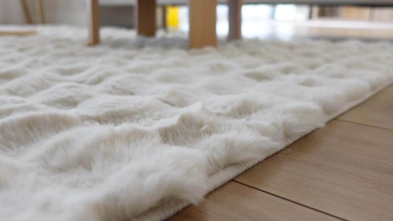 White Fur Rug on Wooden Floor