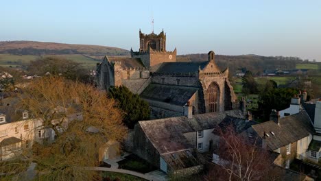 Aerial-footage-of-the-Medieval-village-of-Cartmel-in-the-English-Lake-District-it-has-a-rich-heritage,-and-varied-list-of-activities-for-visitors-and-tourists