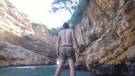 young man in shorts at sea.