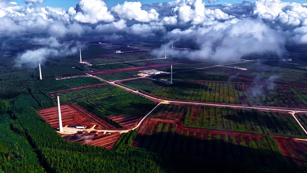 Drone shot of clouds moving above agricultural fields with thick clouds in sky