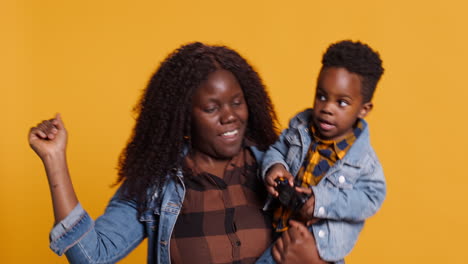 Loving-mother-acting-silly-and-dancing-with-her-infant-son