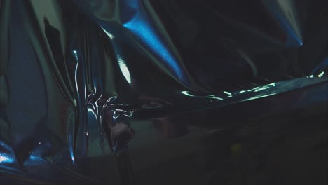 applying dark blue vinyl wrap to a car