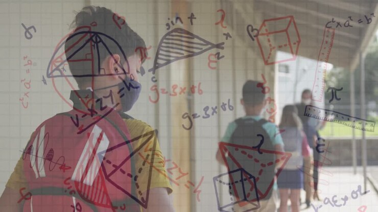 Animation of mathematical equations over diverse schoolchildren and teacher wearing face masks