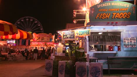 establishing shot of an amusement park carnival or state fair at night  1