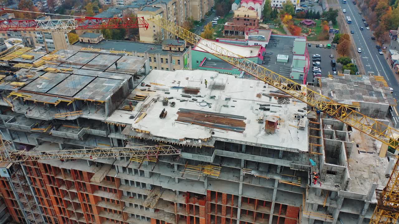 Drone shot of busy construction site. Aerial drone view of construction project in city