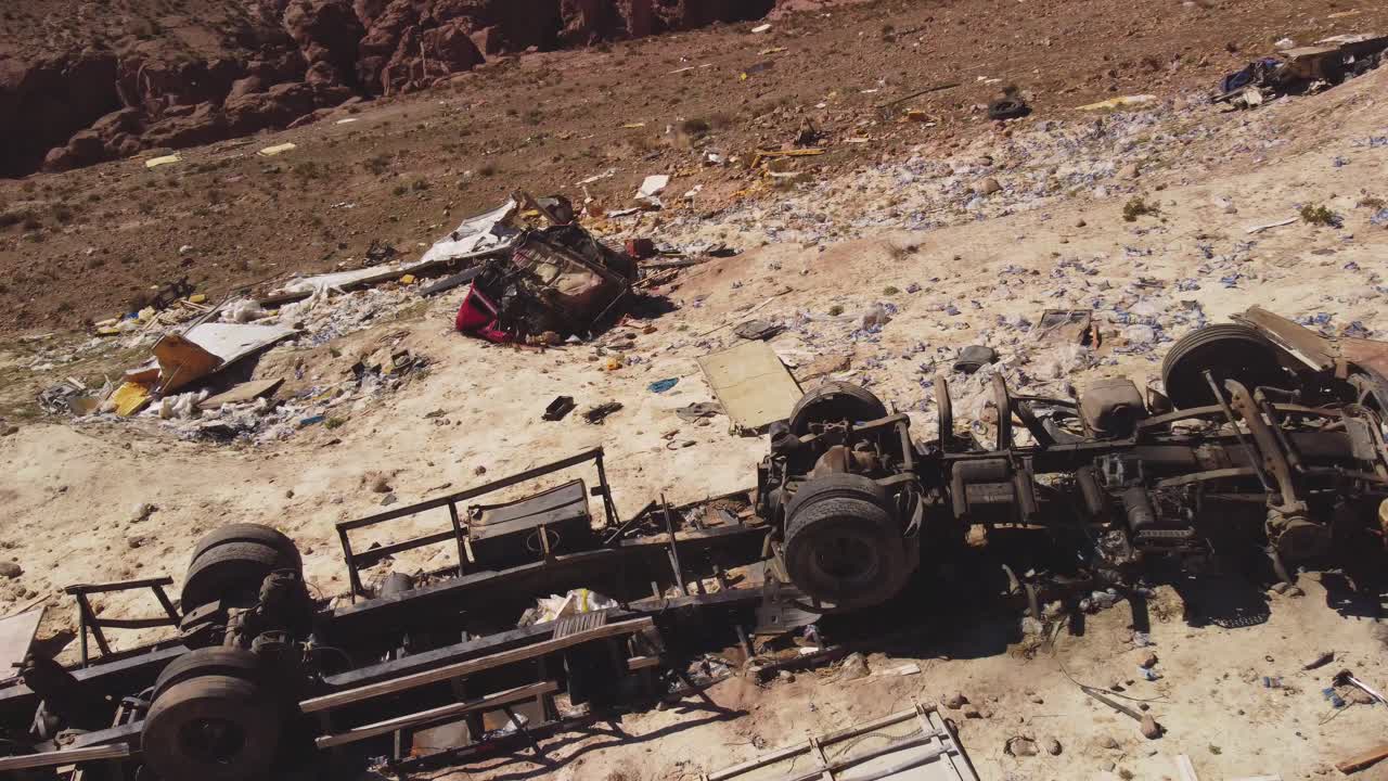 Aerial footage of a crashed truck in the Atacama Desert near San Pedro de Atacama, Chile. Snow-capped Licancabur volcano visible in the background.