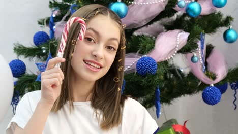 happy teen child is photographed near the christmas tree at home new years mood in children happy teen child is photographed near the christmas tree at home new years mood in children photos for social networks