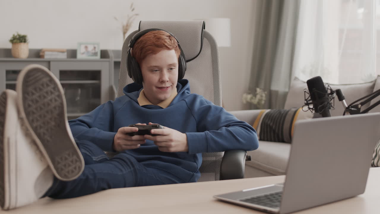 Teenage gamer playing video games at home
