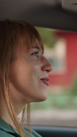 peaceful woman drives car moving to playing favorite song. satisfied lady enjoys listening to music in vehicle on way to work closeup slow motion