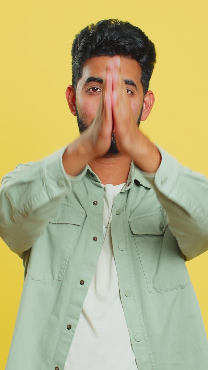 Indian sad man praying making wish asking hopeful help begging apology meditation imploring