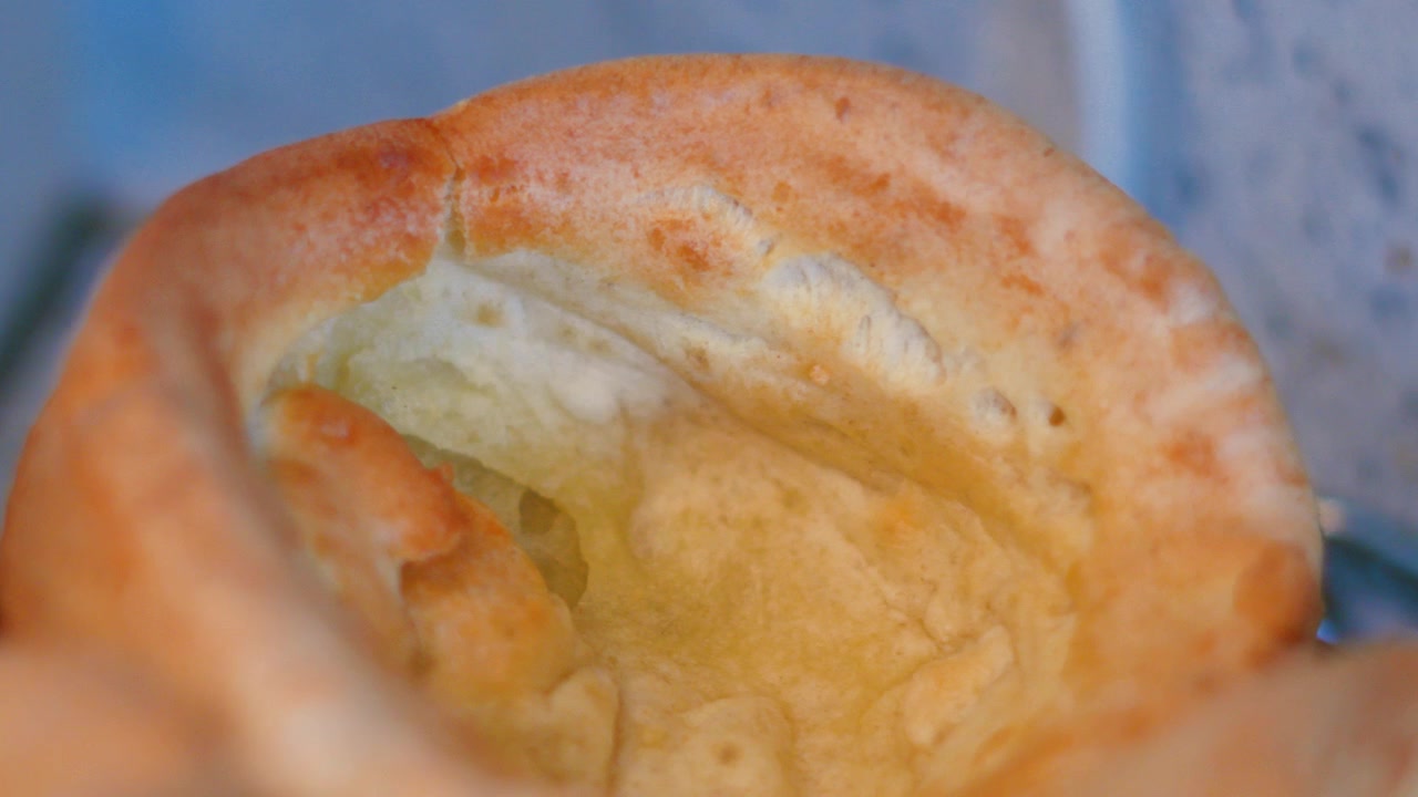 Close-up View of Freshly Baked English Risen Yorkshire Pudding with Crispy Texture. British Cuisine.
