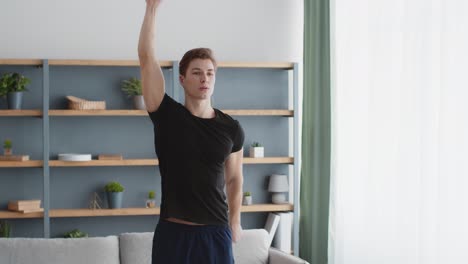 man doing stretching exercises at home