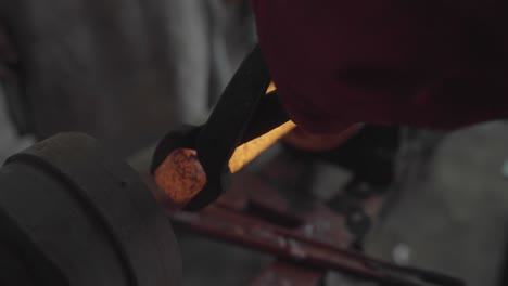 removing forged steel from a metal lathe during spinning process