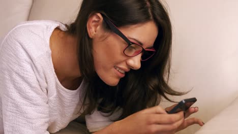 Woman-using-her-phone-on-sofa