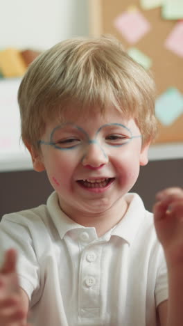 brother and sister play with fidget toys sitting in playroom slow motion. schoolgirl waves hands and boy tries to catch bright wiggle toys laughing happily closeup