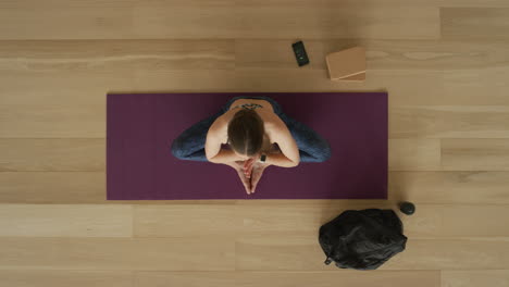 overhead view flexible yoga woman practicing lotus pose enjoying healthy lifestyle exercising in fitness studio training on exercise mat