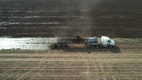 a tanker spreads liquid manure on a wisconsin farm field recently harvested of corn silage