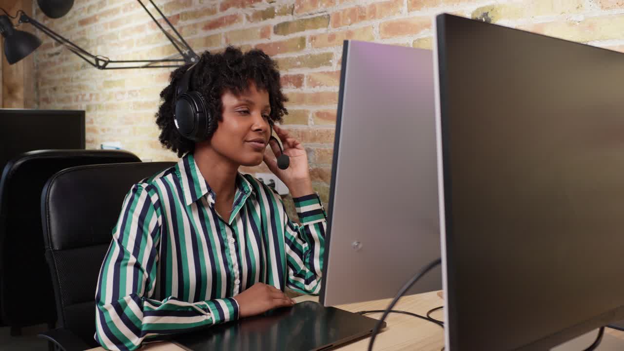Woman working at a computer with a headset
