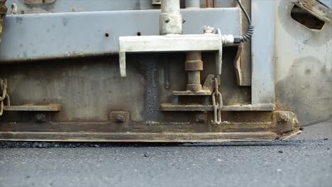 Compressing,-compacting,-leveling-and-smoothing-the-asphalt-road-surface-using-a-Asphalt-Paver-Finisher