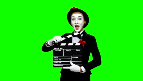 mime holding clapperboard on green screen