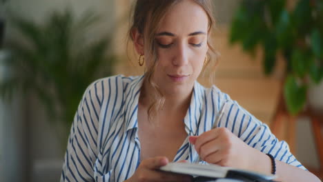 reflective woman taking notes