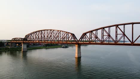 aerial view close to the big four bridge, sunset in louisville, usa - pan, drone shot