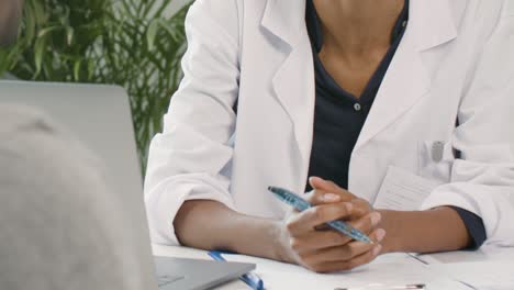 Mid-Section-Female-Doctor-Discusses-Results-With-Patient