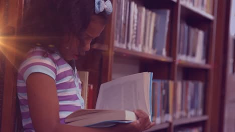 Animation-of-light-trails-over-biracial-girl-reading-book