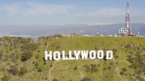 wonderful fly over hollywood sign with snowy mountains in los angeles