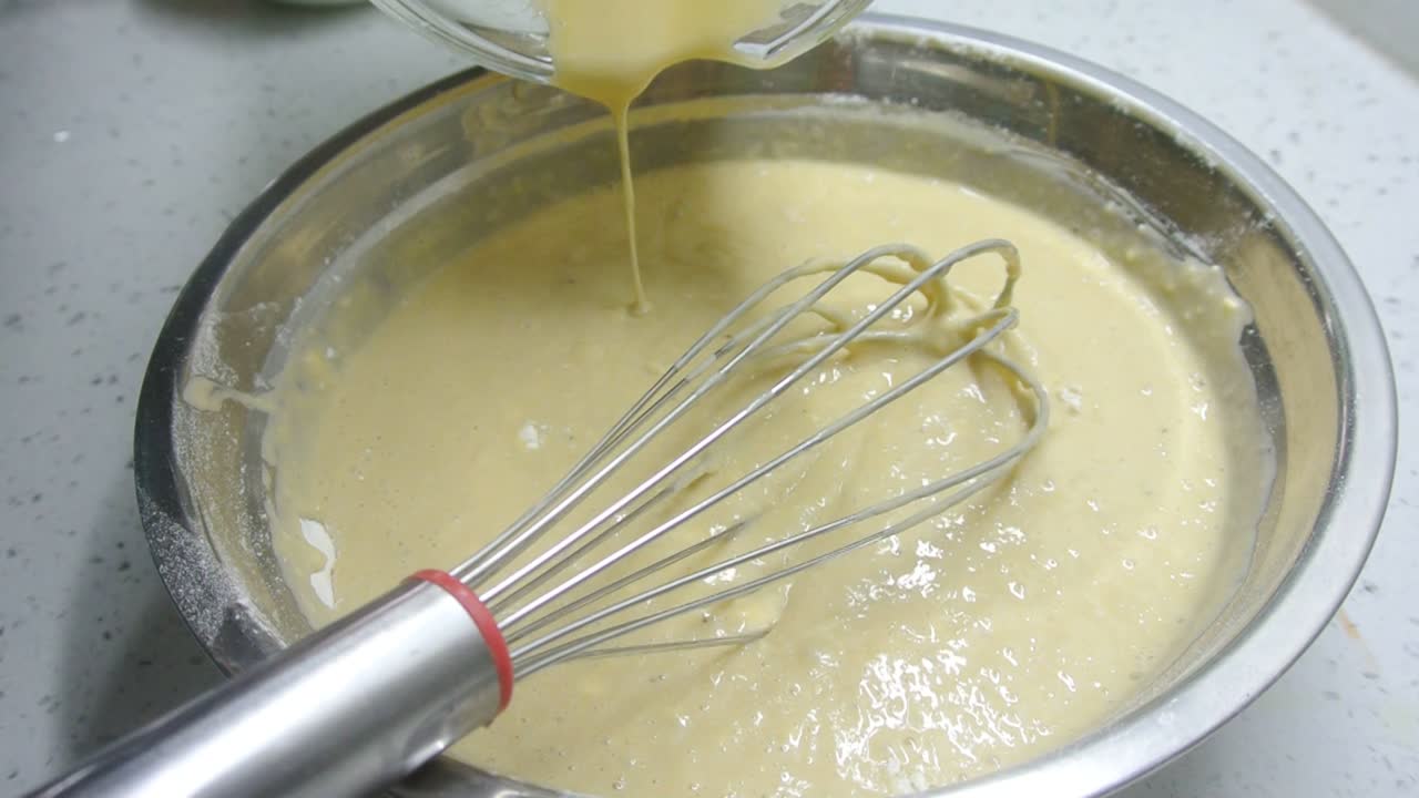 Mix the flour and other ingredients until well blended manually. It is the early stage of the baking bread and cakes process. This will take some time to get a good mix.