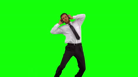 businessman listening to music while jumping