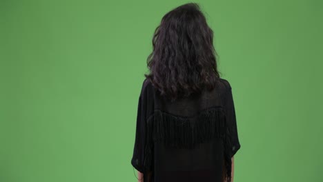 rear view of young beautiful woman looking for something