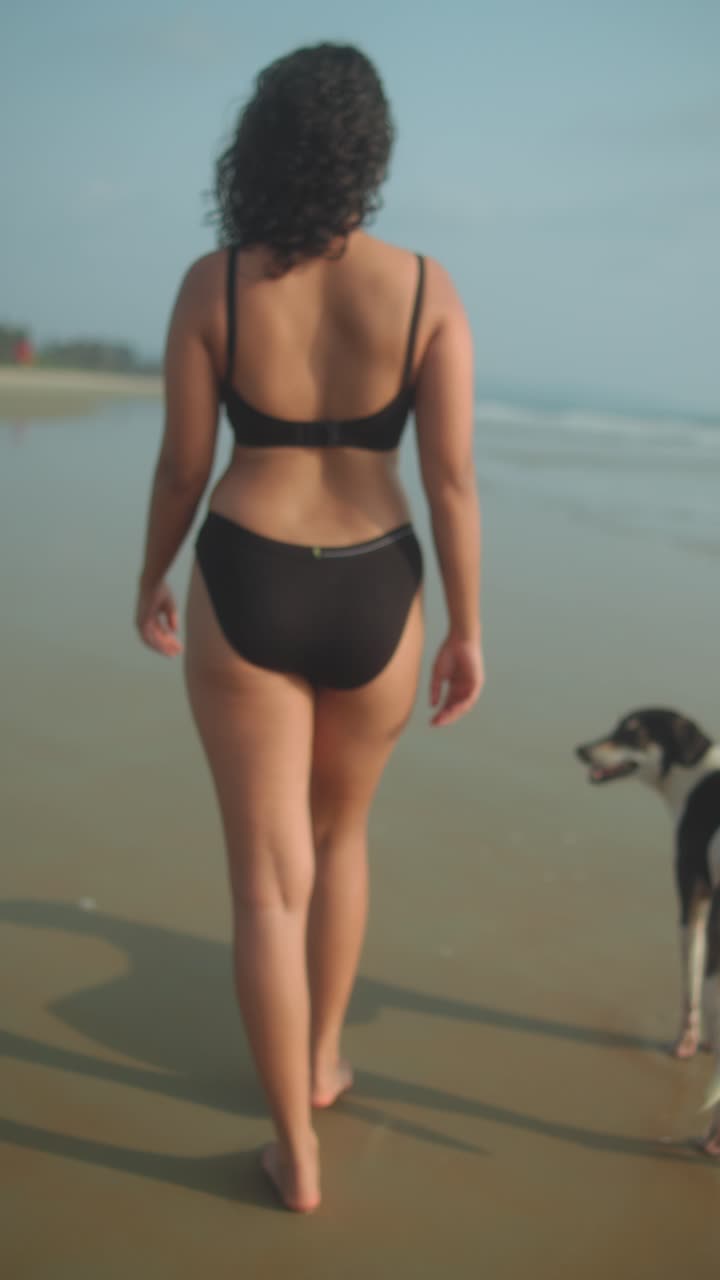 Walking on the beach with a dog, sunny, natural mood, focus on the ocean horizon