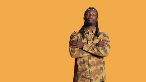 Portrait-of-guy-with-dreads-smiling-in-studio-set