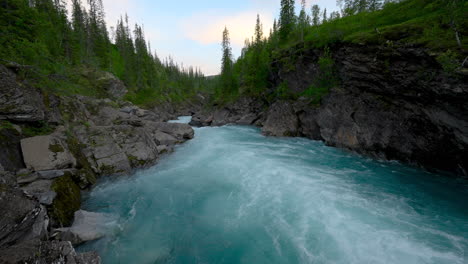 marmorslottet glacier water flowing down the rocky path in forest - marblecastle marble rock in northern norway