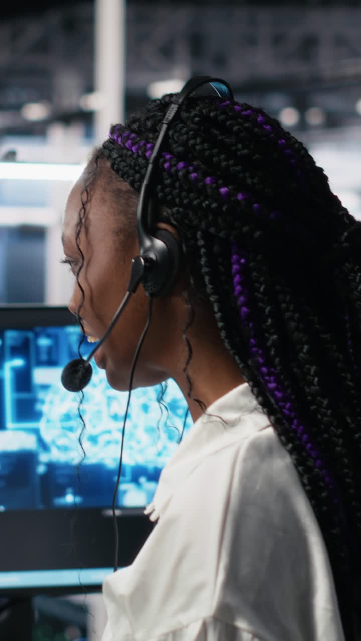 Vertical video Admin in data center wearing headset assisting users with AI