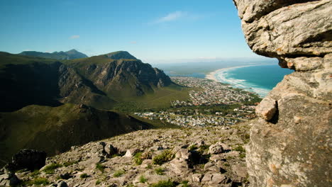 panning shot from vantage point of mountain and pristine beach along coastline, hermanus, south africa