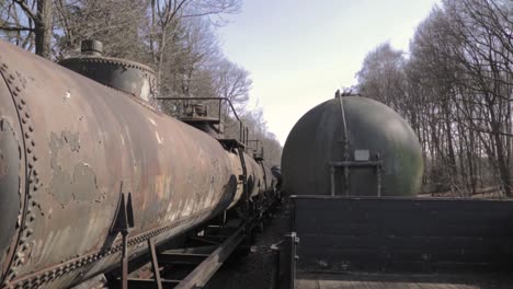 rusty tank cars on an abandoned railroad line