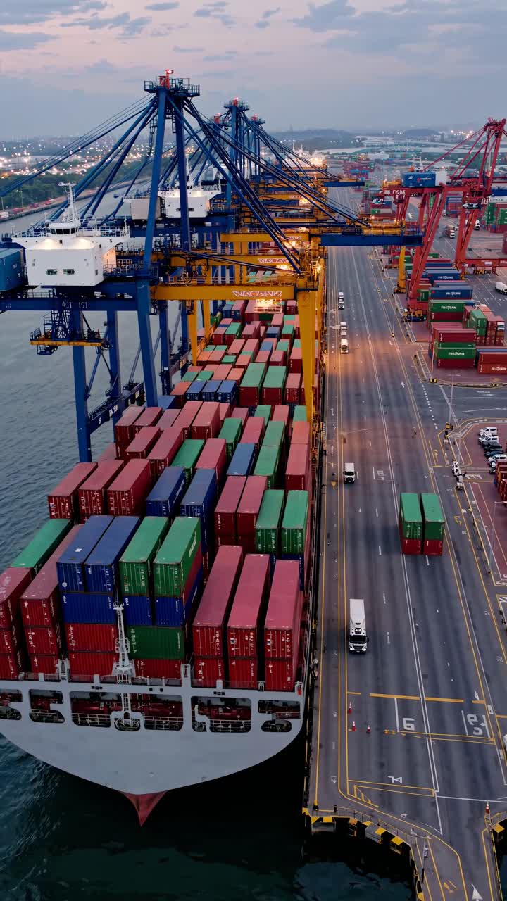 Aerial view of a bustling port with colorful containers and cranes, showcasing global trade