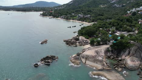 360 degrees aerial shot of rocky beaches and green hills in koh samui thailand