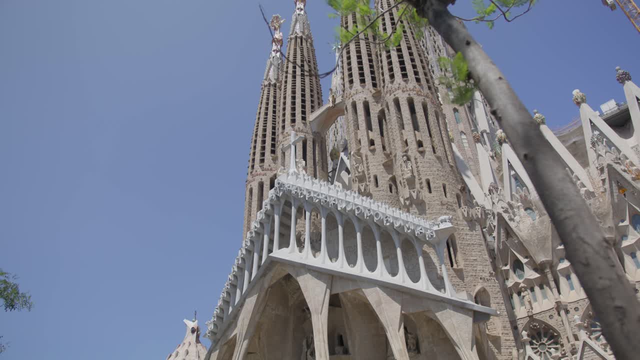 Tree Blow in Wind Sky View, The Famous Sagrada Familia Cathedral in Barcelona Spain in the Early Morning in 6K
