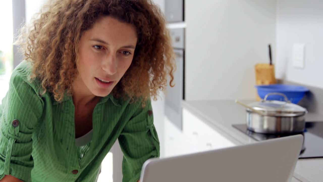 Focused woman typing on laptop