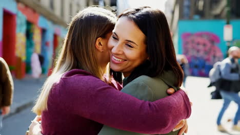 two women hugging in the city