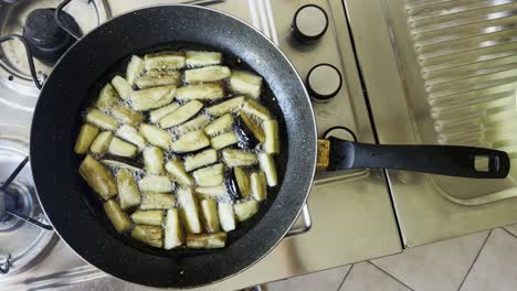 cooking pan fried vegetarian eggplant in vegetable oil