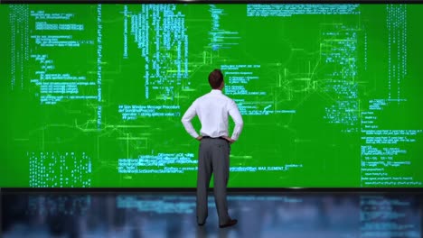 Businessman coding on green interface