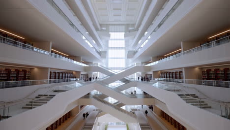grand modern library interior with intersecting staircases and bookshelves